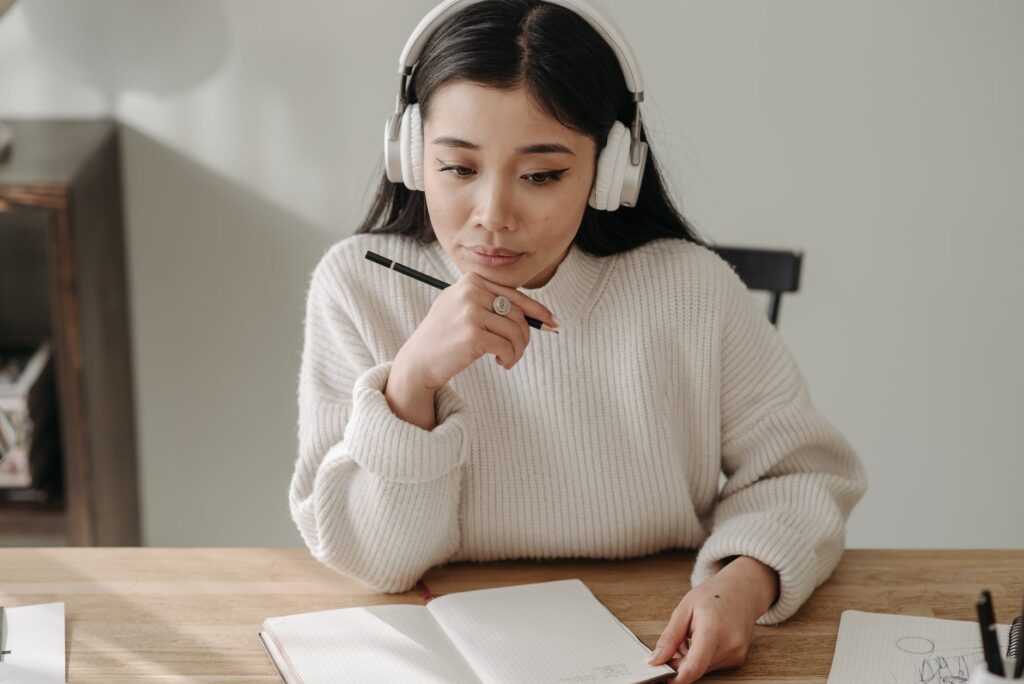 woman in white sweater studying